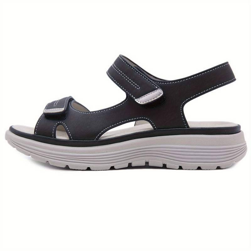 Schwarze Sandale mit Klettverschluss, ergonomischer Sohle und robustem Design. Ideal für Komfort und Stil im Sommer. Hochwertige Materialien.