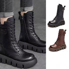 Schwarze Lederstiefel mit dicker Sohle, Schnürung und seitlichem Reißverschluss. Trendige Damenstiefel, ideal für Herbst und Winter.
