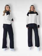 Damen-Outfit: Schwarz-weißes Colorblock-Set mit Pullover und Hose, ideal für Freizeitmode. Trendige Damenbekleidung, bequem und stilvoll.