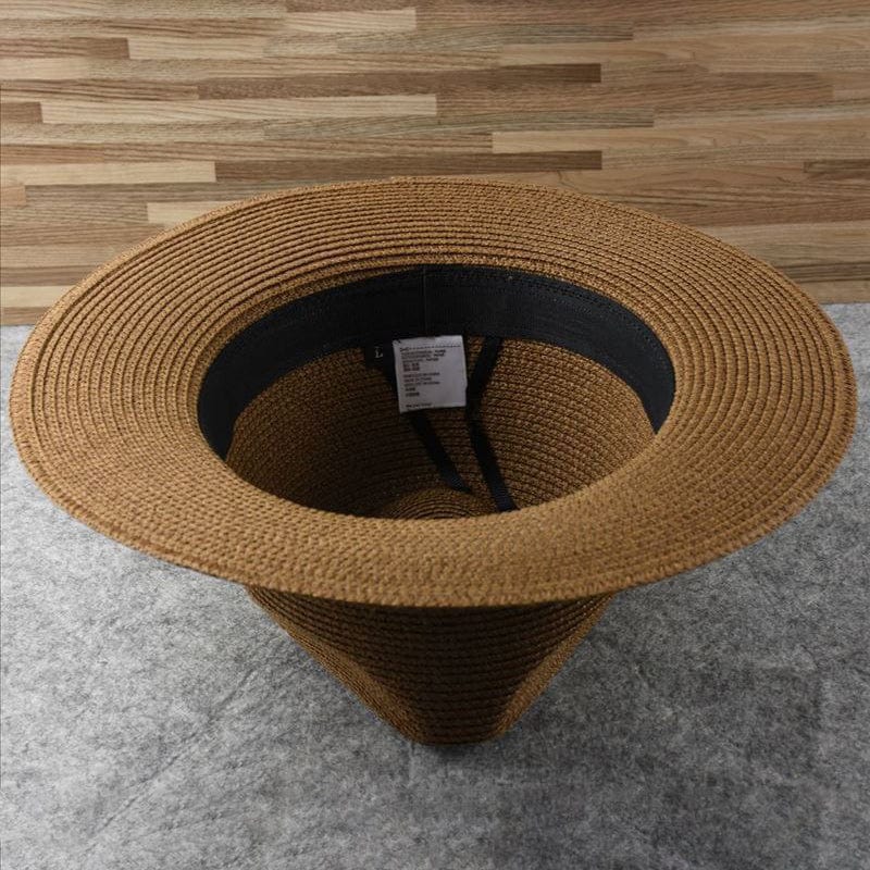Brauner Strohhut mit breiter Krempe, ideal für Sommermode und Sonnenschutz.