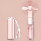Tragbarer rosa Mini-Ventilator mit Katzenohren-Design, USB-aufladbar, kompakt und faltbar.