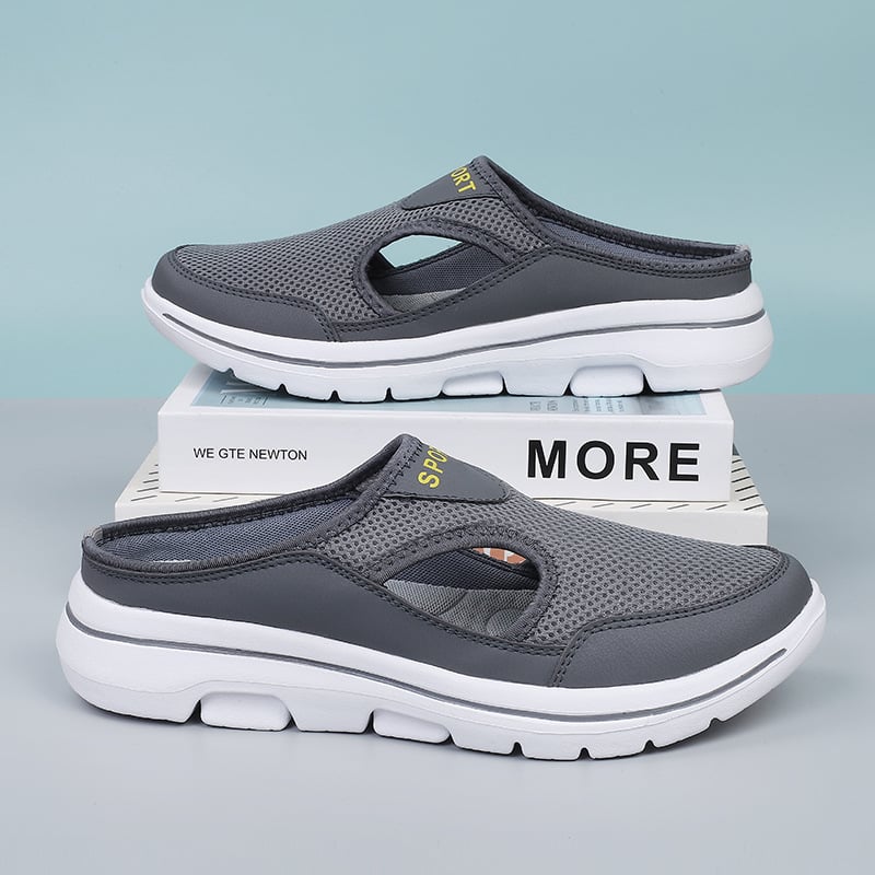 Graue Sportschuhe mit atmungsaktivem Mesh-Obermaterial und weißer Sohle, ideal für Freizeit und Outdoor-Aktivitäten. Bequeme und stilvolle Clogs.