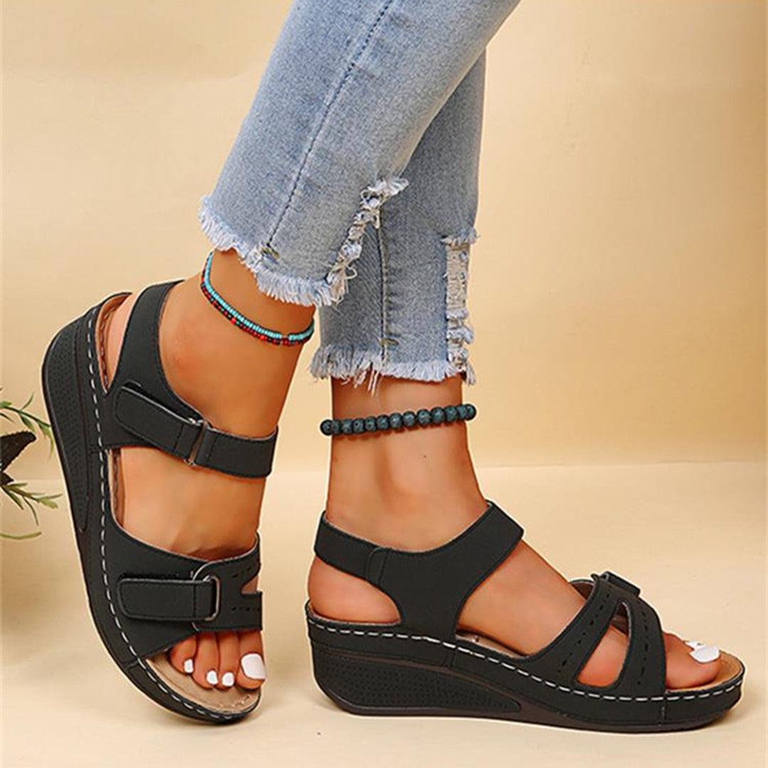 Schwarze Damen-Sandalen mit Keilabsatz, verstellbaren Riemen und bequemer Sohle. Perfekt für Sommermode und lässige Outfits.