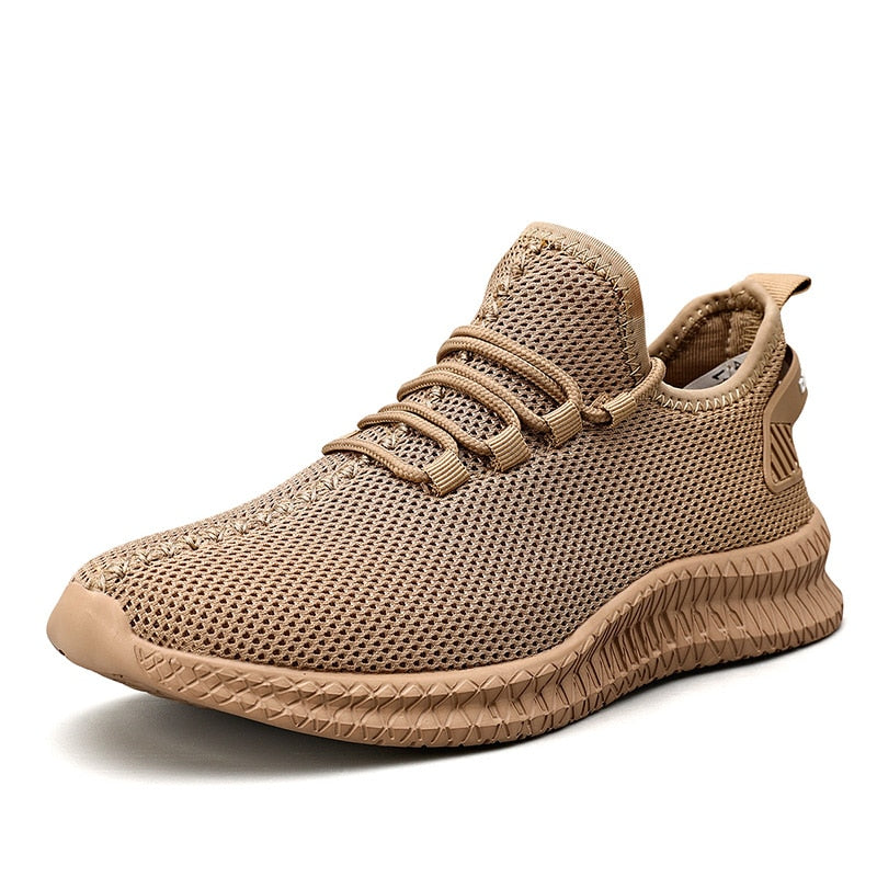 Beiger Sneaker mit atmungsaktivem Mesh-Obermaterial, rutschfester Sohle und modernem Design. Perfekt für Sport und Freizeit.