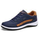 Dunkelblauer Sneaker mit braunen Akzenten, bequemer Sportschuh, ideal für Herren, modisch und vielseitig, perfekt für Freizeit und Alltag.