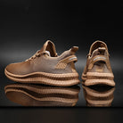Braune Sportschuhe mit atmungsaktivem Mesh-Obermaterial, rutschfester Sohle und modernem Design. Ideal für Fitness und Freizeit.