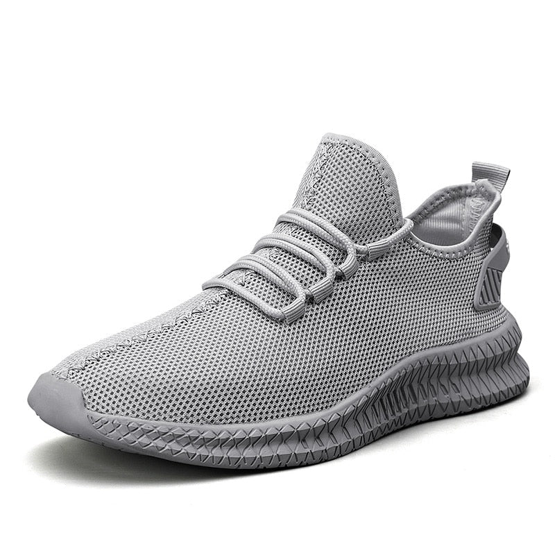 Grauer Sneaker mit atmungsaktivem Mesh-Obermaterial, rutschfester Sohle und modernem Design. Perfekt für Sport und Freizeit.