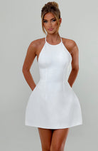Weißes Cocktailkleid mit Neckholder, figurbetontem Schnitt und eleganter Silhouette. Perfekt für Partys und besondere Anlässe.