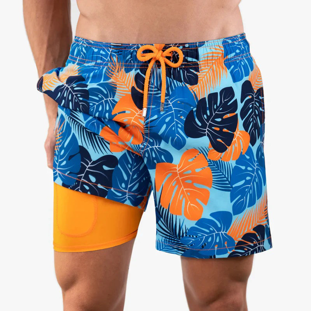 Bunte Herren-Badeshorts mit tropischem Blattmuster, blau-orange, elastischer Bund.