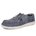 Herren-Slipper aus blauem Canvas, leicht und bequem. Modische, flache Schuhe für Männer, ideal für Freizeit und Alltag.