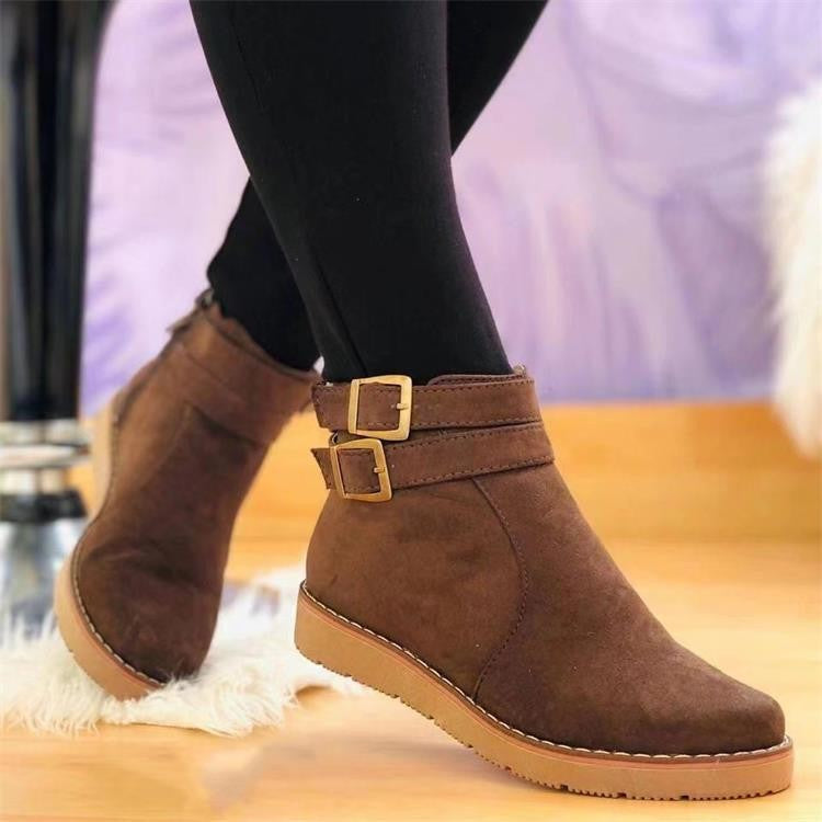 Damen Stiefeletten aus braunem Wildleder mit doppelten Schnallen, flachem Absatz und rutschfester Sohle. Modische Herbst- und Winterstiefel.