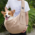 Person trägt Corgi in beiger Hundetragetasche, Outdoor, bequem, Haustiertransport.