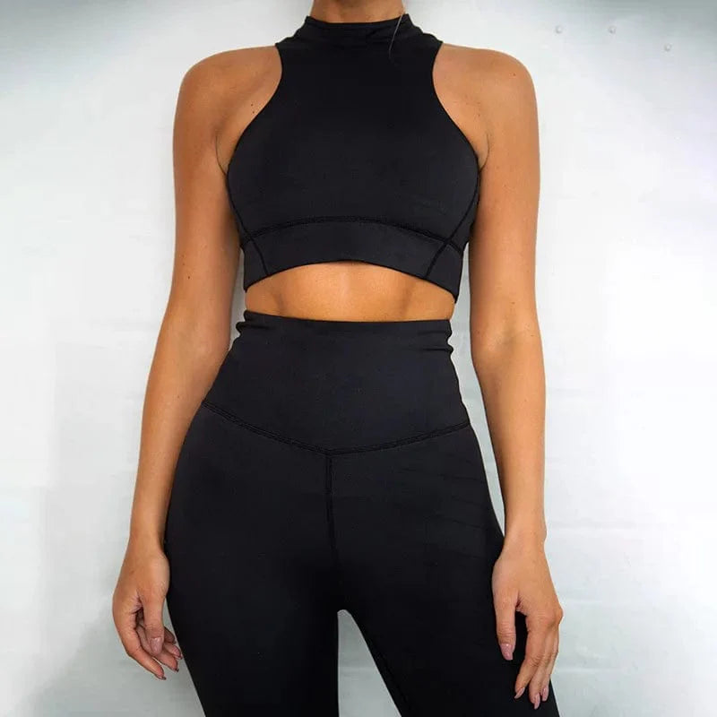 Schwarzes Sport-Set für Damen, bestehend aus ärmellosem Crop-Top und hoch taillierter Leggings. Ideal für Fitness, Yoga und Freizeit.