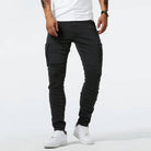 Mann in schwarzer Cargo-Hose und weißen Sneakers, lässiger Stil, Streetwear-Mode.