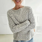 Damenpullover aus grobem Strick in Creme und Grau, lässig und bequem. Perfekt für Herbstmode, kombiniert mit Jeans für einen entspannten Look.