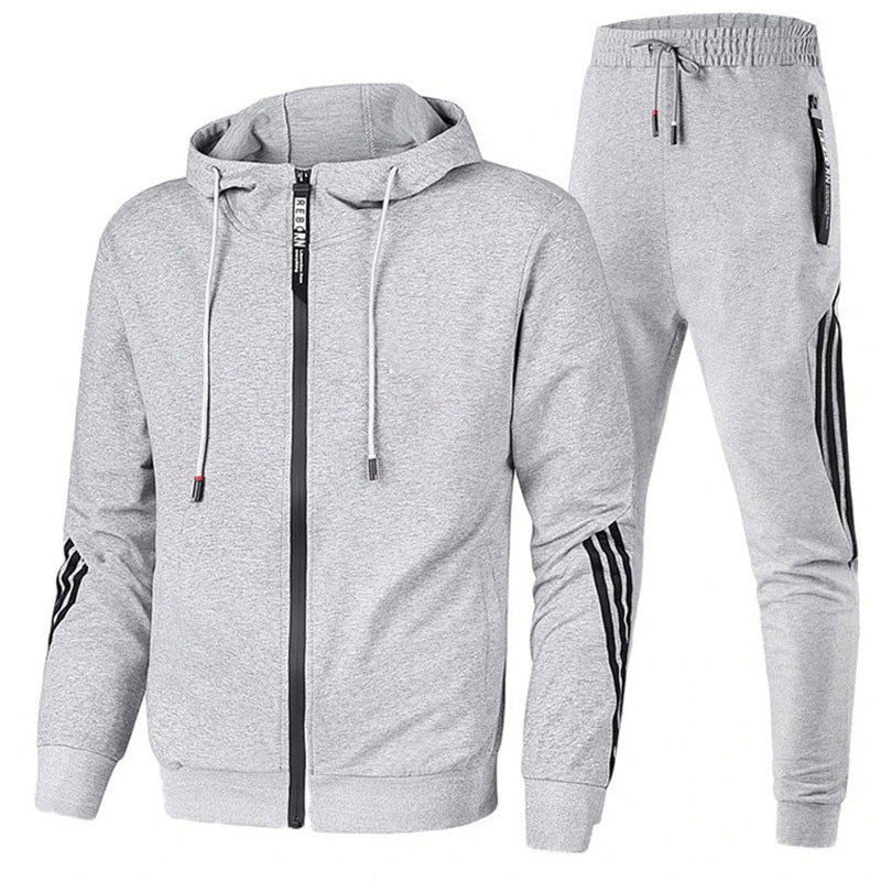 Grauer Herren-Trainingsanzug mit Kapuzenjacke und Jogginghose, ideal für Sport und Freizeit. Bequemer Schnitt, modisches Design, atmungsaktives Material.