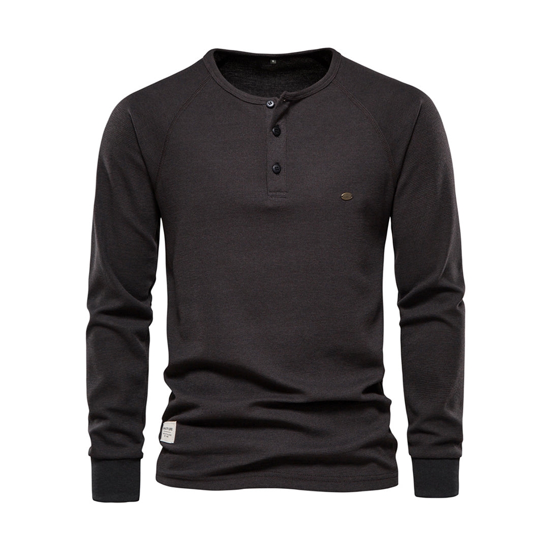 Dunkelgraues Langarmshirt für Herren, aus Baumwolle, mit Knopfleiste. Ideal für Freizeit und Alltag. Modernes Design, bequem und stilvoll.