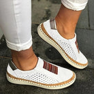 Weiße Damen-Sneaker mit bunten Streifen, atmungsaktivem Design und bequemer Sohle. Perfekt für Freizeit und Alltag. Trendige Schuhe 2023.