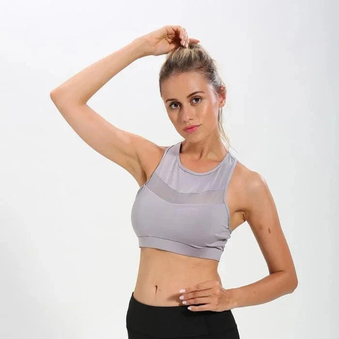 Grauer Sport-BH mit dekorativem Mesh, ideal für Fitness und Yoga. Atmungsaktiv, bequem und stilvoll für aktive Frauen.