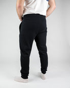 Schwarze Jogginghose für Herren, bequem und stilvoll, ideal für Sport und Freizeit. Elastischer Bund, weiches Material, perfekte Passform.